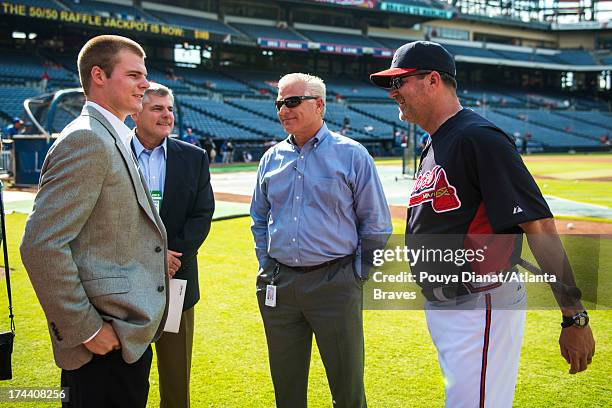 Atlanta Braves first round draft pick Jason Hursh, Atlanta Braves general manager Frank Wren and Roger McDowell of the Atlanta Braves before the game...