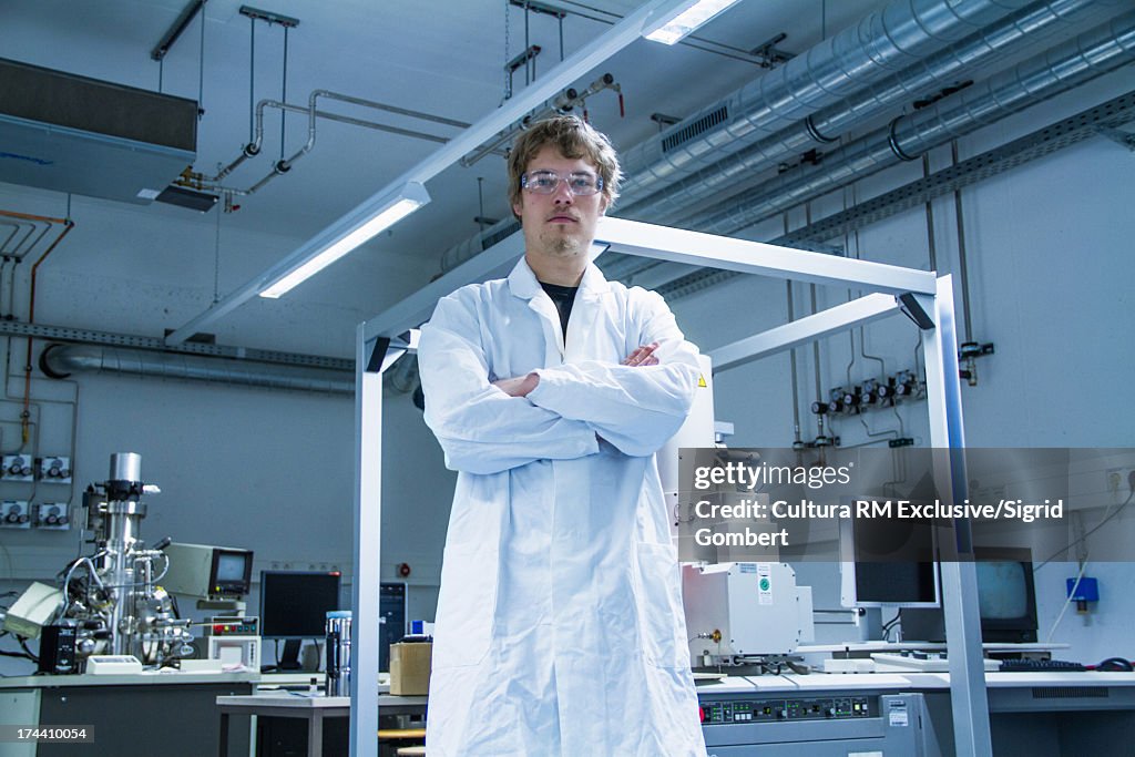 Young male scientist standing in lab