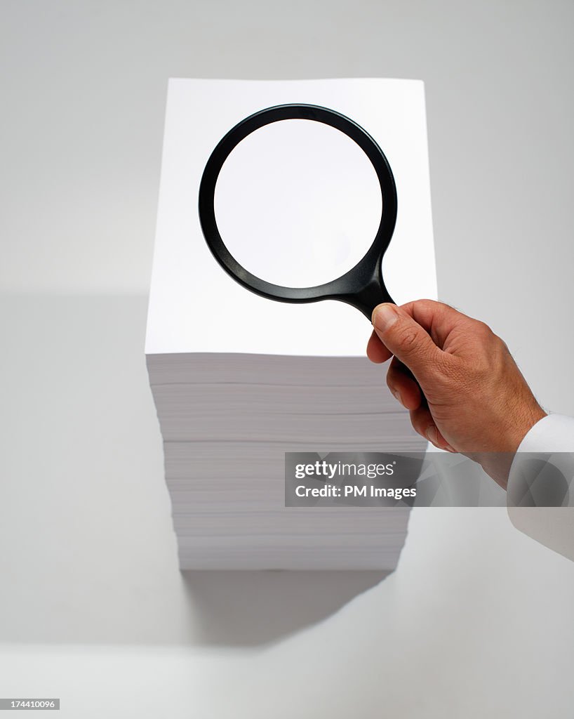 Hand searching with magnifying glass