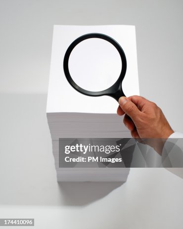 Hand searching with magnifying glass Hand searching with magnifying glass