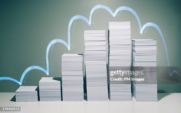 glowing light trail over stacks of paper - bureaucracy stock pictures, royalty-free photos & images