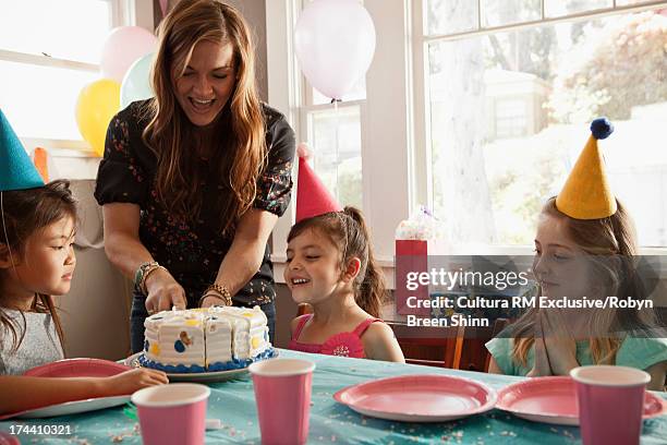 mother cutting birthday cake - paper plate stock pictures, royalty-free photos & images