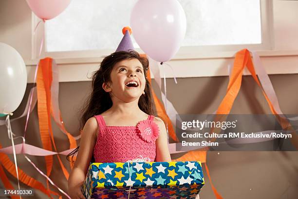 child holding present - the red party in los angeles stock-fotos und bilder