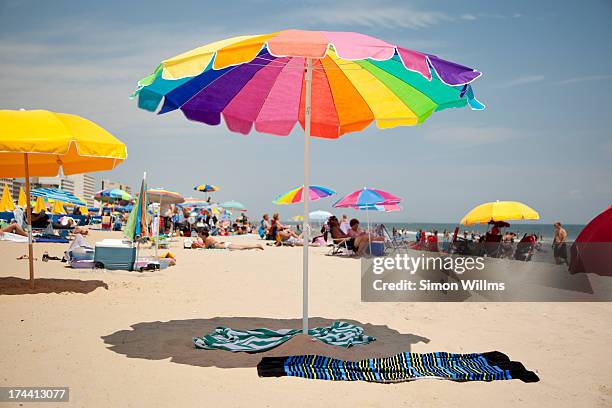 beach umberealla - beach umbrella sand stock-fotos und bilder