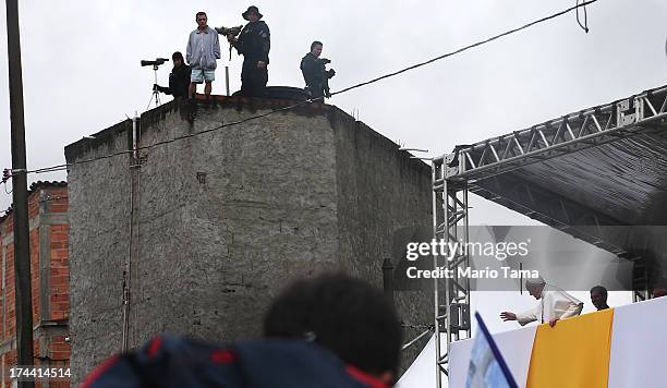 Pope Francis gestures to the crowd in the Varghina favela, or shantytown, on July 25, 2013 in Rio de Janeiro, Brazil. More than 1.5 million pilgrims...