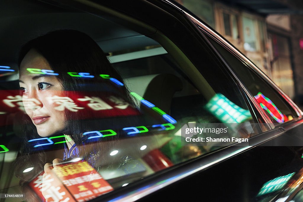 Young Woman In Backseat of Car, Reflected Lights