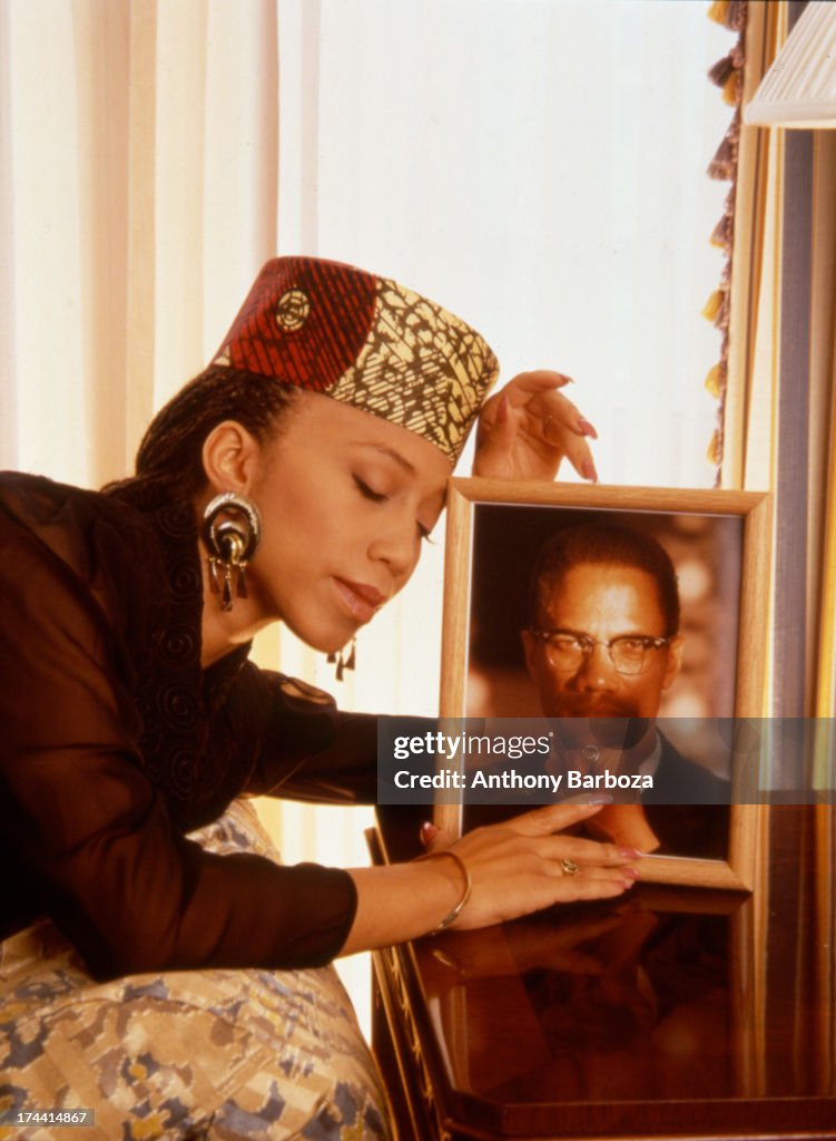 Attallah Portrait of Attallah Shabazz as she poses with a framed portrait of ...
