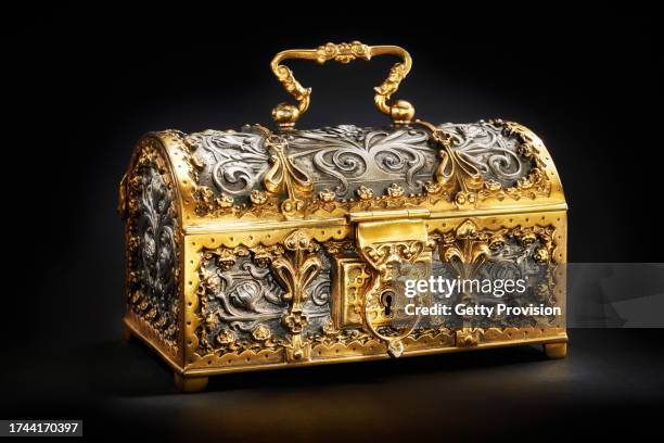 small treasure chest with gold and silver decorations on black background - schmuckschatulle stock-fotos und bilder