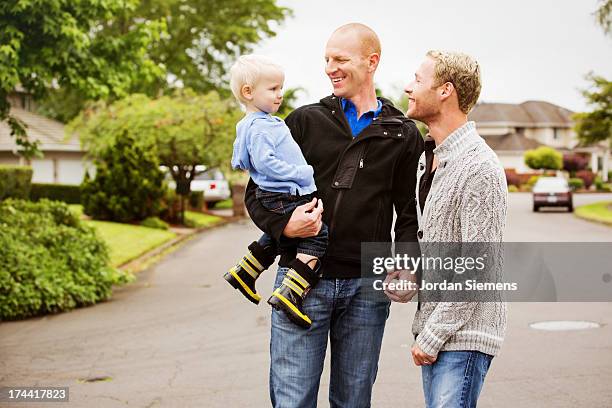 A gay couple walking with their son.