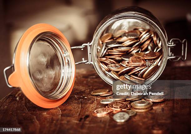 jar of coins - jar stock pictures, royalty-free photos & images