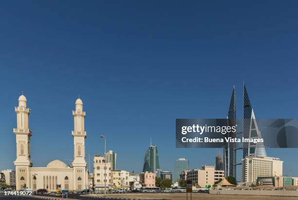 bahrain. manama. mosque and bahrain world trade ce - bahrain city stock pictures, royalty-free photos & images