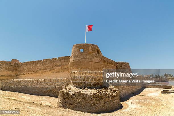 bharain. muharraq. bahrain flag over arad fort. - bahraini flag stock pictures, royalty-free photos & images