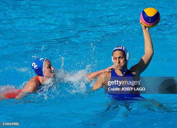 Russia's Alexandra Antonova is held back by the Netherlands's Yasemin Smit during the preliminary rounds of the women's water polo at the FINA World...