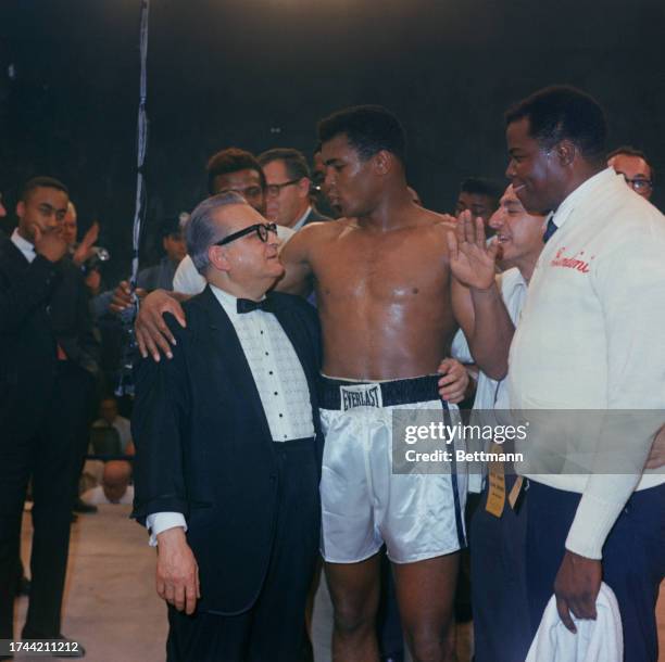 Heavyweight boxing champion Muhammad Ali pictured with members of his entourage after defeating Sonny Liston to retain his title in Lewiston, Maine,...