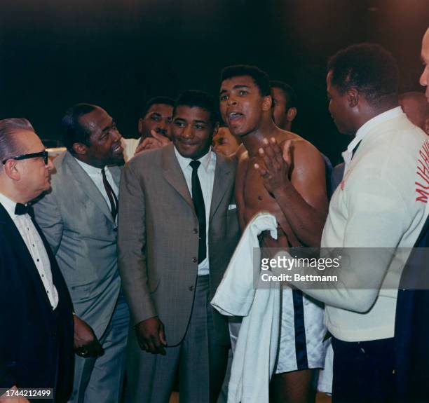 Heavyweight boxing champion Muhammad Ali talks with former champion Floyd Patterson after defeating Sonny Liston to retain his title, Lewiston,...