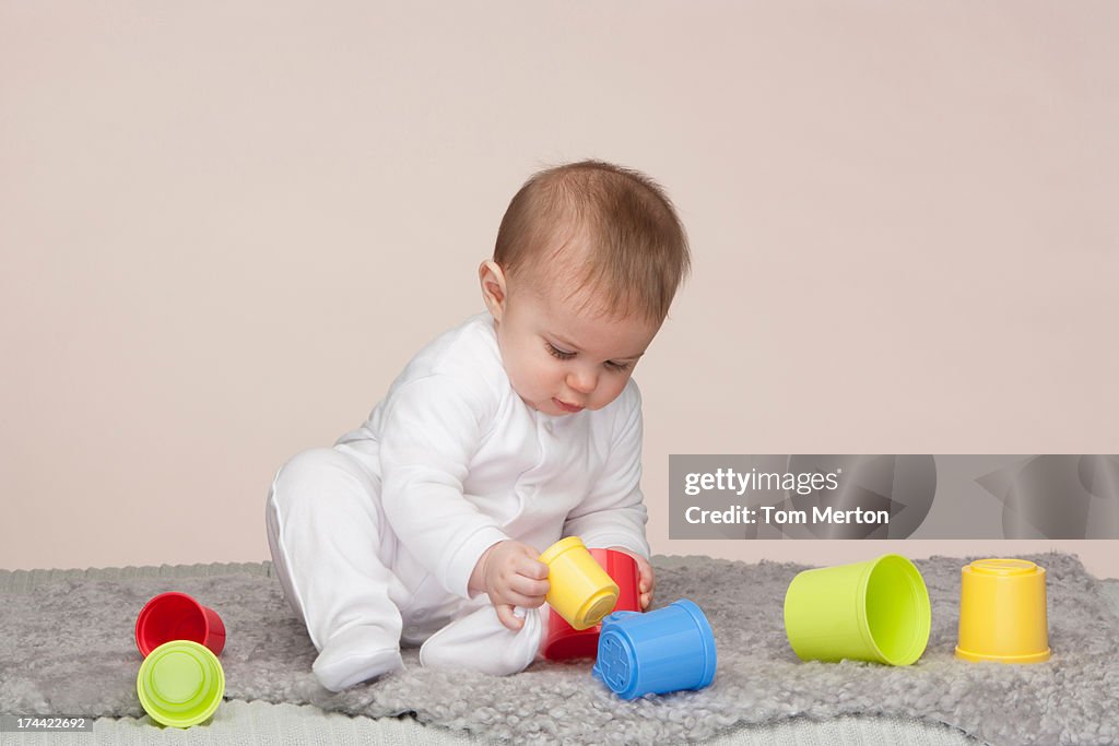 A baby playing with building toys