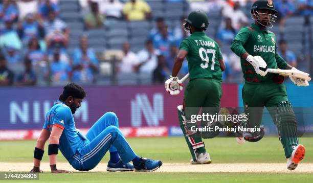 Hardik Pandya of India reacts in their follow through after bowling during the ICC Men's Cricket World Cup India 2023 between India and Bangladesh at...