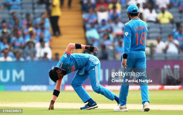 Hardik Pandya of India reacts in their follow through after bowling during the ICC Men's Cricket World Cup India 2023 between India and Bangladesh at...