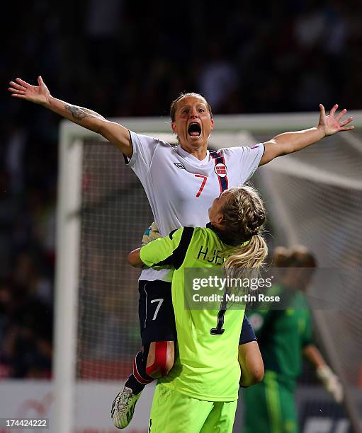 Trine Roenning of Norway celebrate with team mate Ingrid Hjelmseth after winning the UEFA Women's Euro 2013 semi final match between Norway and...