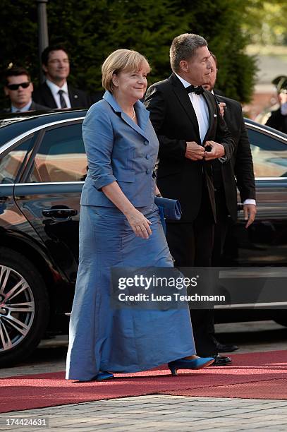 German Chancellor Angela Merkel and Joachim Sauer attend the Bayreuth Festival opening on July 25, 2013 in Bayreuth, Germany.