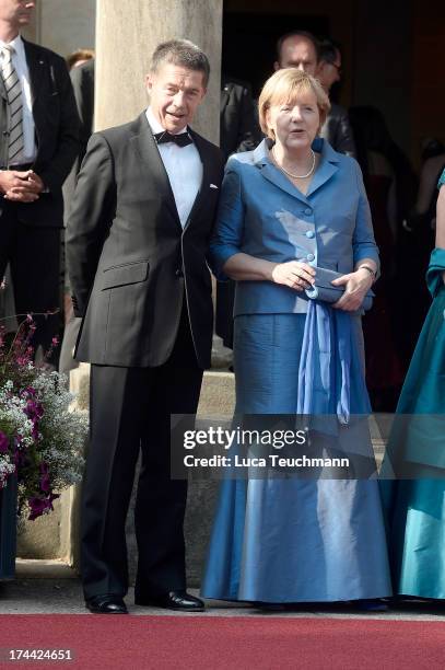 German Chancellor Angela Merkel and Joachim Sauer attend the Bayreuth Festival opening on July 25, 2013 in Bayreuth, Germany.