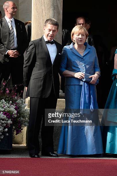 German Chancellor Angela Merkel and Joachim Sauer attends the Bayreuth Festival opening on July 25, 2013 in Bayreuth, Germany.