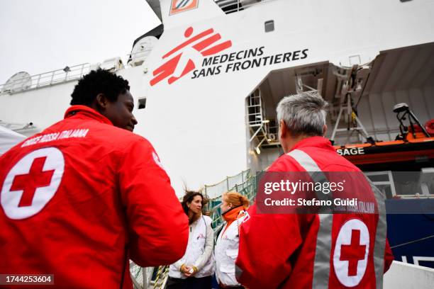 Red cross staff attends a migrant inside the Geo Barents ship during disembark in the port of Genoa on October 18, 2023 in Genoa, Italy. The Migrant...