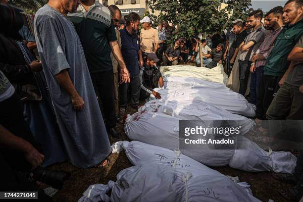 People carry body bags at the morgue of Nasser Hospital, arrived to take the dead bodies of their relatives who lost their lives in Israeli...