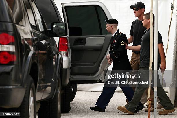 Army Private First Class Bradley Manning is escorted by military police as he leaves after the first day of closing arguments in his military trial...