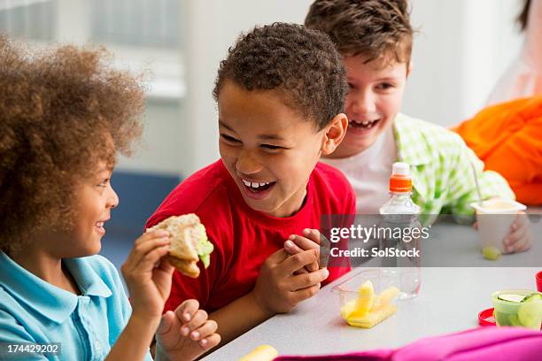 young students finding lunchtime funny - boy packlunch stockfoto's en -beelden