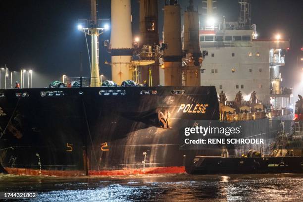 The cargo ship "Polesie" is guided into the harbour of Cuxhaven, northern Germany, on early October 25 after it collided with another cargo ship the...