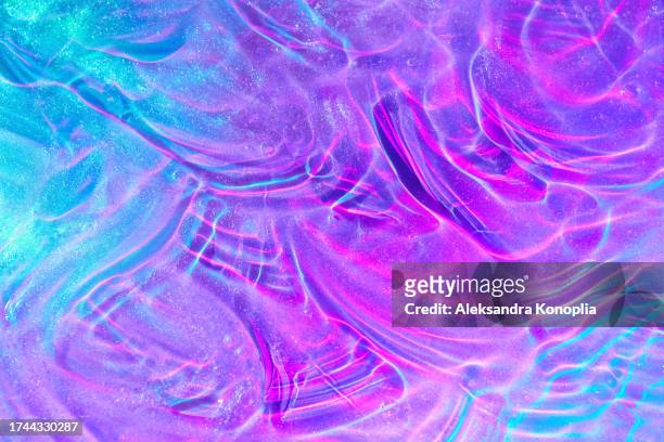 beautiful purple, pink and blue transparent space alien glitter slime background texture - glitschig stock-fotos und bilder