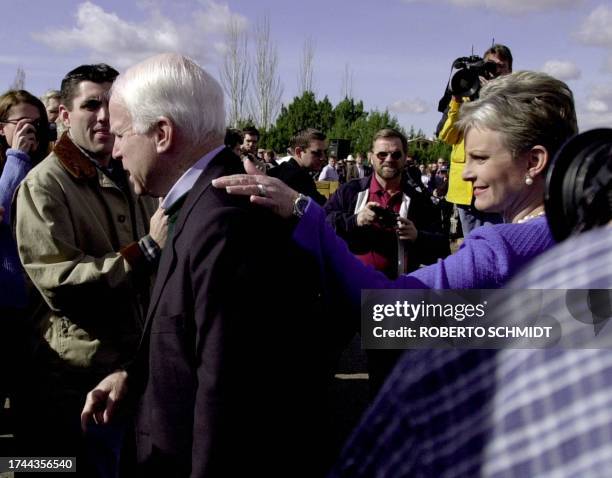 Arizona Senator John McCain makes his way to the podium with his wife Cindy before he announced the suspension of his campaign to be the Republican...