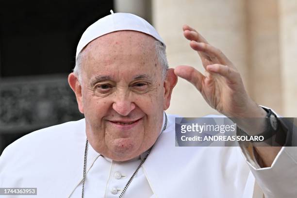Pope Francis waves to the crowd as he leaves the weekly general audience at St Peter's Square in the Vatican, on October 25, 2023.
