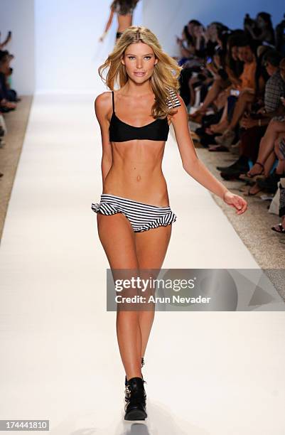 Model walks the runway during the Lolli Swimwear fashion show at Mercedes-Benz Fashion Week Swim 2014 - Runway>> at Raleigh Hotel on July 22, 2013 in...