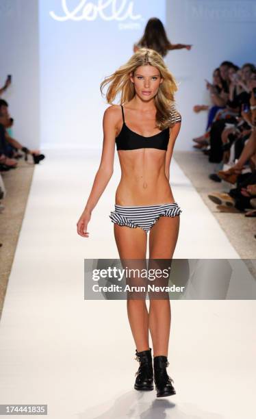 Model walks the runway during the Lolli Swimwear fashion show at Mercedes-Benz Fashion Week Swim 2014 - Runway>> at Raleigh Hotel on July 22, 2013 in...