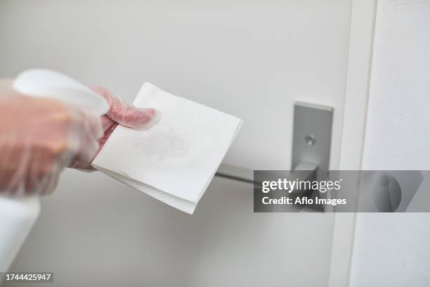 Japan Man Disinfecting Door Knob With Alcohol High-Res Stock Photo