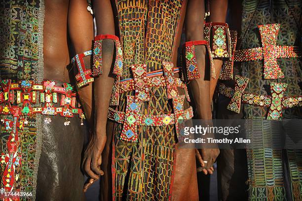 men holding hands wearing tribal designs - indigenous culture stock-fotos und bilder