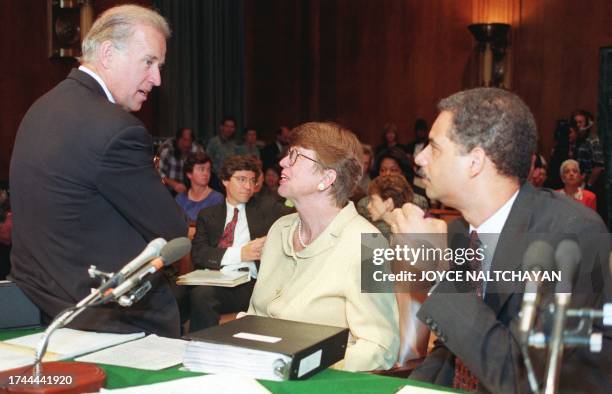 Attorney General Janet Reno and Deputy Attorney Genral Eric Holder listen to Sen. Joseph Biden , D-DE, before the start of hearings conducted by the...