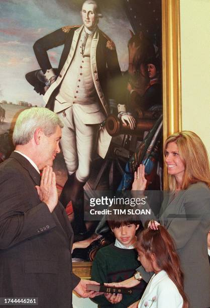 Speaker of the House Newt Gingrich administers the oath of office 21 April to Rep-elect Mary Bono, , R-CA, during a reenactment of her swearing-in...