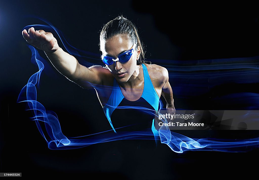 Female swimmer swimming with light trails