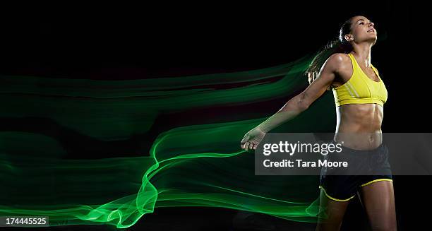 female runner winning race with light trails - female streaking imagens e fotografias de stock