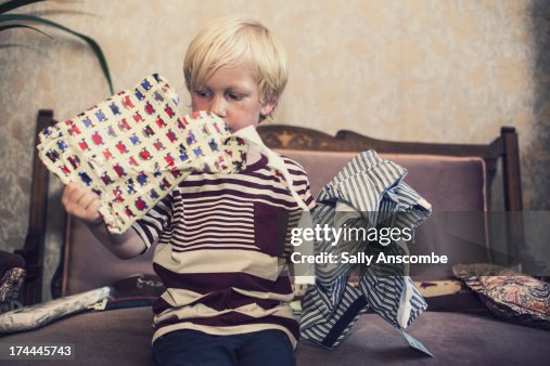 Little boy opening a birthday present Little boy opening a birthday present