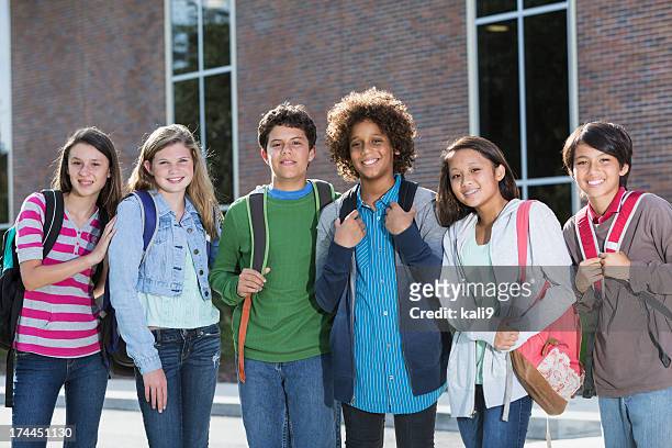 students standing outside building - pre adolescent child stock pictures, royalty-free photos & images