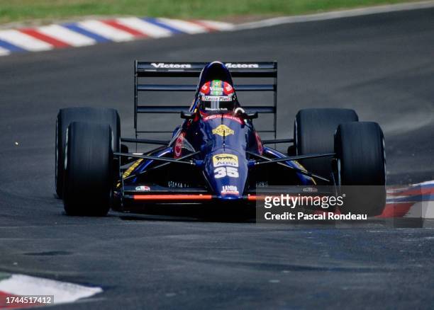 Eric van de Poele from Belgium drives the Modena Team SpA Lambo 291 Lamborghini V12 over the curbs during practice for the Formula One Mobil 1 German...