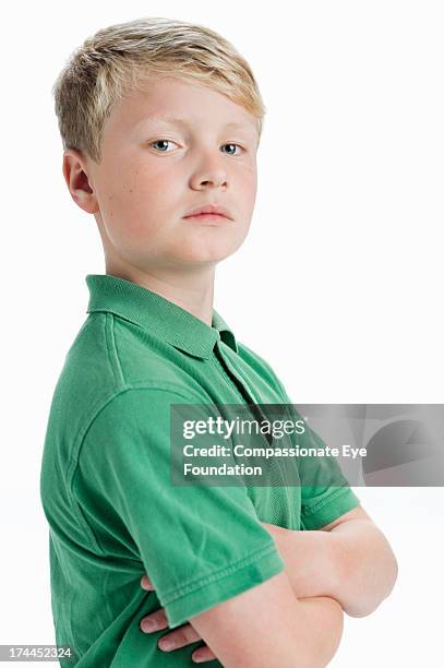 boy (11-12) with arms folded - boy looking over shoulder stock pictures, royalty-free photos & images