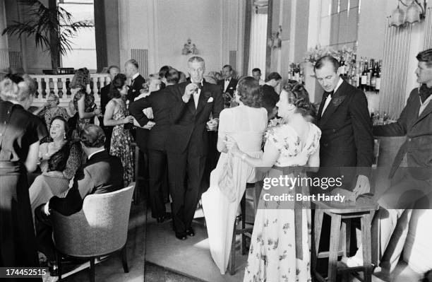 Guests in formal dress, at the bar for cocktails before dinner at the Grand Hotel in Torquay, August 1947. Original publication: Picture Post - 4418...