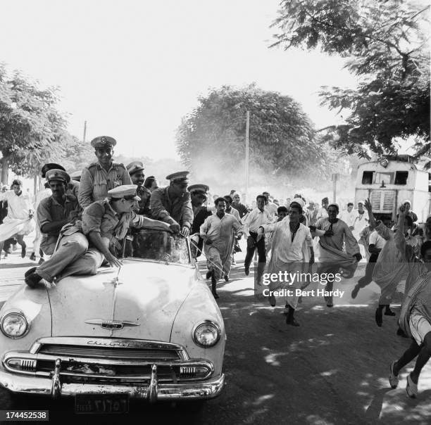 Enthusiastic Egyptian crowds surround General Muhammad Naguib on his progress through the Delta country in Egypt, October 1952. The previous July,...