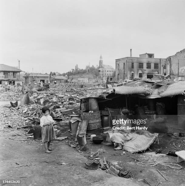 Woman and two children in their makeshift shelter in the ruins of Incheon, South Korea, September-October 1950. The city has been badly damaged after...