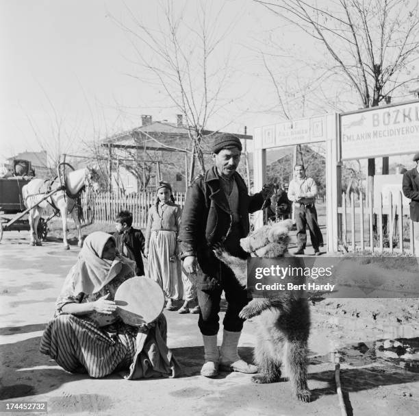 Turkish gypsies with a performing bear, Turkey, 1953. Original publication: Picture Post - 6621 - Performing Bears - unpub. 1953